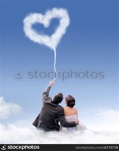 Just married couple sitting on the flossy cloud