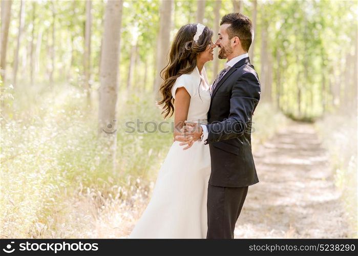 Just married couple together in poplar background
