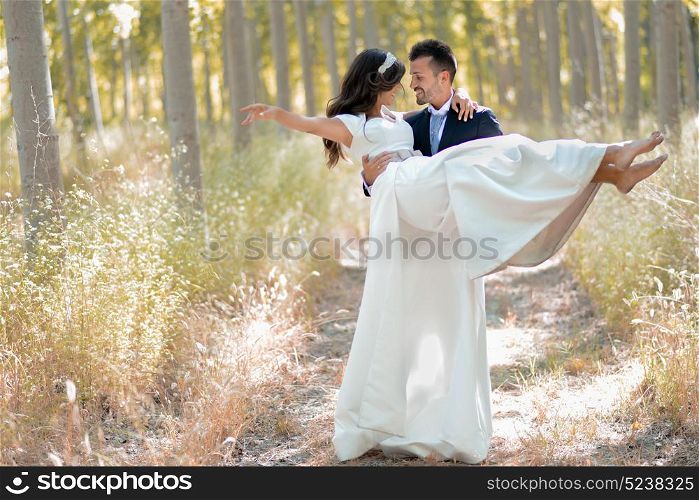 Just married couple together in poplar background