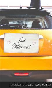 Just Married poster hanging on a wooden wall