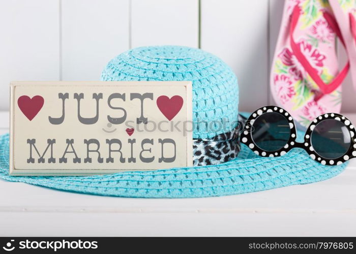 Just married sign with things to go on vacation to the beach