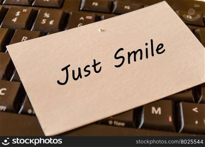Just smile concept on black keyboard background