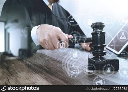 justice and law concept.Male judge in a courtroom striking the gavel,working with digital tablet computer docking keyboard on wood table,virtual interface graphic icons diagram
