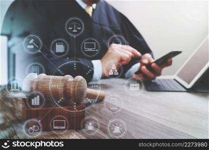 justice and law concept.Male judge in a courtroom with the gavel,working with smart phone,digital tablet computer docking keyboard on wood table,virtual interface graphic icons diagram