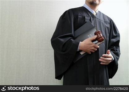 justice and law concept.Male judge in a courtroom with the gaveland holy book and digital tablet computer