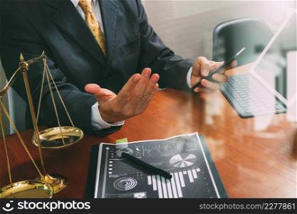 justice and law concept.Male lawyer in office with the gavel,working with smart phone,digital tablet computer docking keyboard,brass scale,on wood table,filter effect