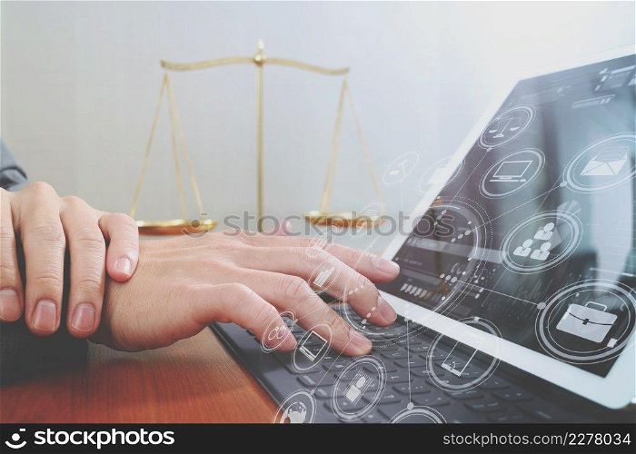 justice and law concept.Male lawyer in office with the gavel,working with smart phone and digital tablet computer and brass scale on wood table,virtual graphic icons screen diagram