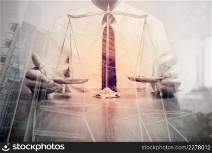 justice and law concept.Male lawyer in the office with brass scale on wooden table with london city background,double exposure