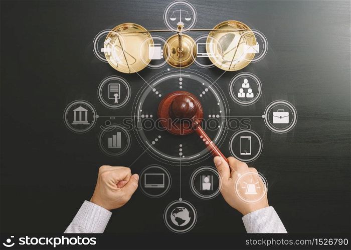 justice and law concept.Top view of Male judge hand in a courtroom with the gavel and brass scale on dark wood table with Vr diagram