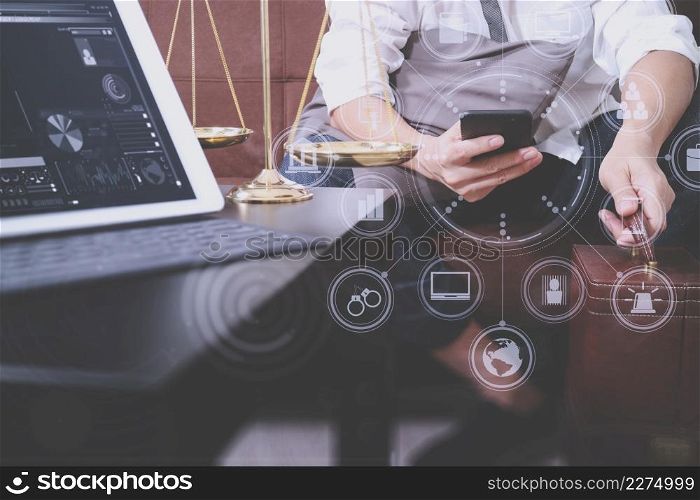Justice and Law context.Male lawyer hand sitting on sofa and working with smart phone,digital tablet computer docking keyboard with gavel and document on living table at home,virtual interface graphic icons diagram