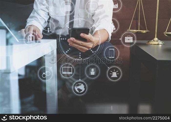 Justice and Law context.Male lawyer hand sitting on sofa and working with smart phone,digital tablet computer docking keyboard with gavel and document on living table at home,virtual interface graphic icons diagram