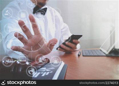 Justice and Law context.Male lawyer hand working with smart phone,digital tablet computer docking keyboard with gavel and document on wood table,virtual interface graphic icons diagram