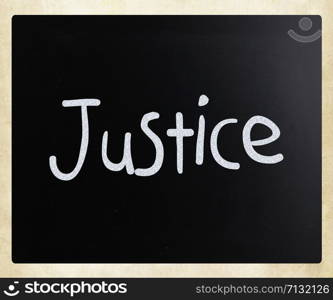 ""Justice" handwritten with white chalk on a blackboard"