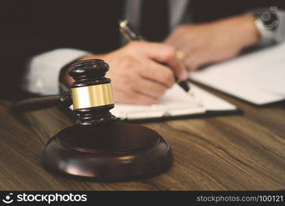 justice lawyer / judge gavel working with legal documents in a court room