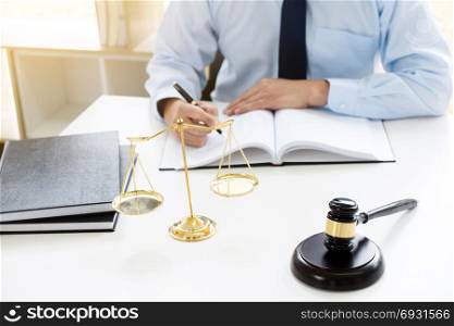 justice lawyer / judge gavel working with legal documents in a court room