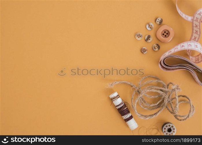 jute thread button measuring tape spool colored background. Resolution and high quality beautiful photo. jute thread button measuring tape spool colored background. High quality beautiful photo concept