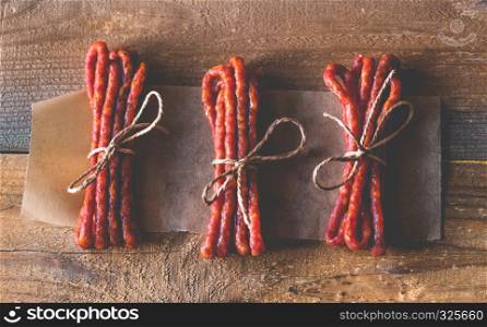 Kabanosy sausages on the wooden background