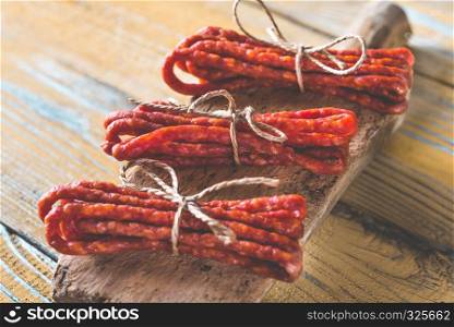 Kabanosy sausages on the wooden background