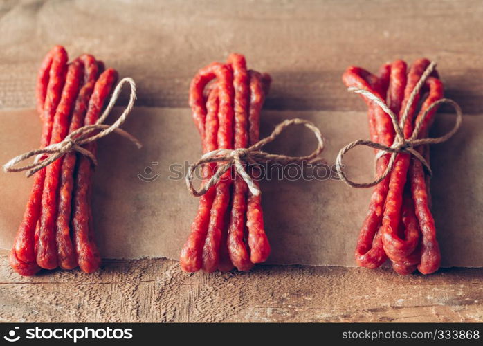 Kabanosy sausages on the wooden background