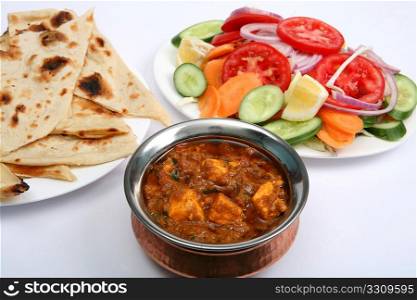 Kadai paneer cheese curry in a cardamon gravy, with naan bread and salad
