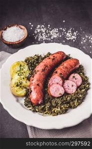 Kale with cooked sausage and potatoes