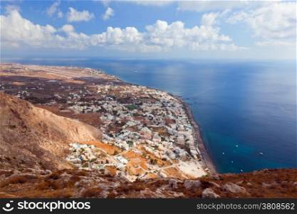 Kamari town on Santorini island, Greece. Cliff over the Aegean sea