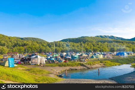 KAMCHATKA, RUSSIA - JULE 27 2019: Tent camp in Malka near the hot mineral springs