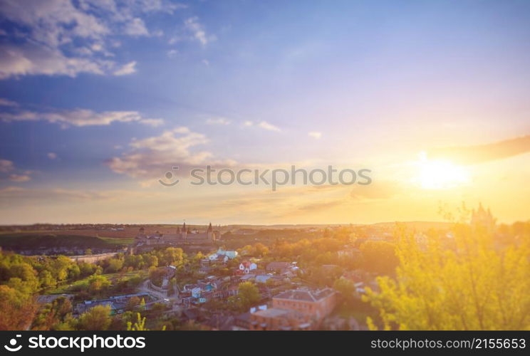 Kamianets Podilskyi cityscape under sunshine and colorful sky. Kamianets Podilskyi cityscape