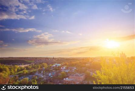 Kamianets Podilskyi cityscape under sunshine and colorful sky. Kamianets Podilskyi cityscape