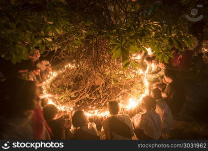 Kanchanaburi, THAILAND - JULY 8: Thai Buddhist monk hands holding candle cup at Sangklaburi temple on July 8, 2017 in Kanchanaburi, Thailand.