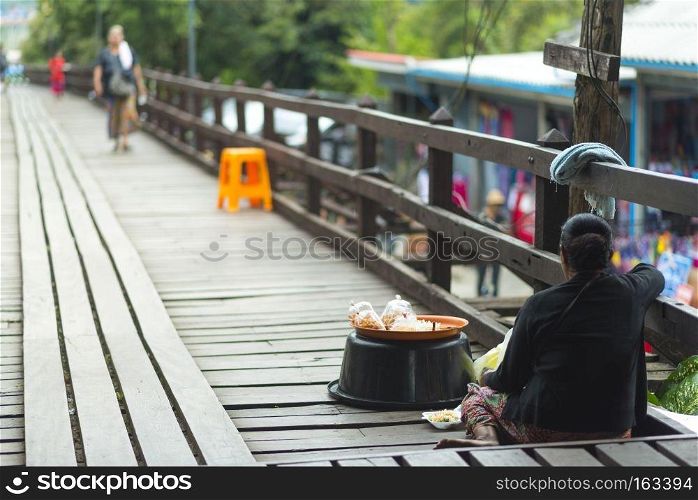 KANCHANABURI, THAILAND - NOVEMBER 22 2015 : people tourist was holiday walk on the wooden bridge at Sangkhla buri, Thailand