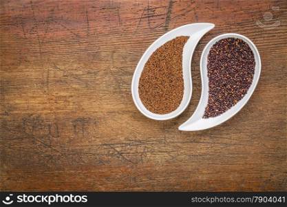kaniwa and black quinoa gluten free grains on on teardrop shaped bowls against rustic wood with a copy space