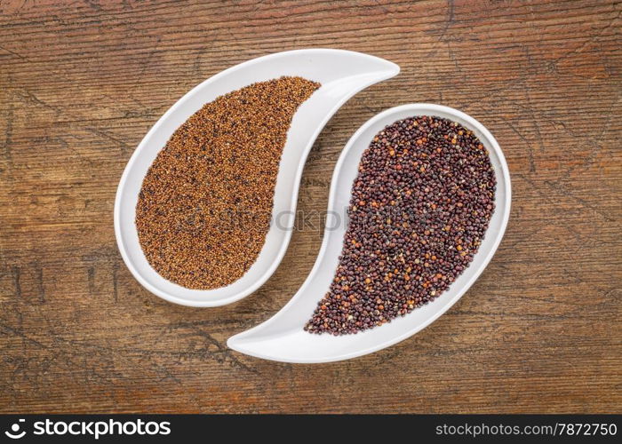 kaniwa and black quinoa grain on on teardrop shaped bowls against rustic wood