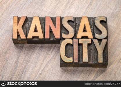 Kansas City word abstract in vintage letterpress wood type against grained wooden background