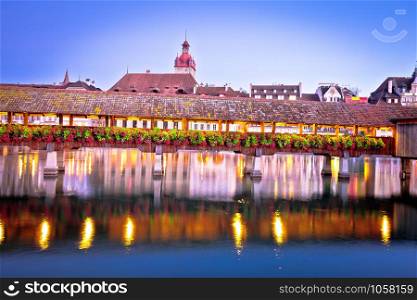 Kapellbrucke historic wooden bridge in Luzern and waterfront landmarks dawn view, town in central Switzerland