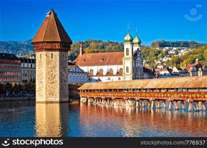 Kapellbrucke historic wooden bridge in Luzern and waterfront landmarks view, town in central Switzerland