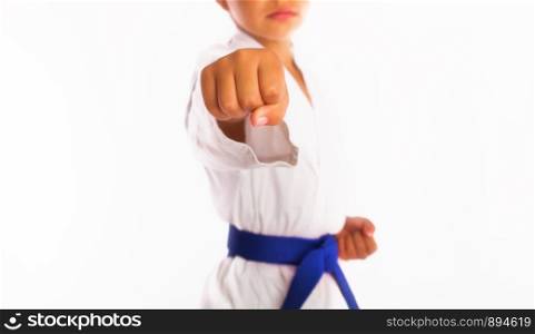 karate girl in white kimono and blue belt punch forward. little girl punch