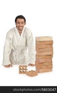 Karate man breaking bricks on white