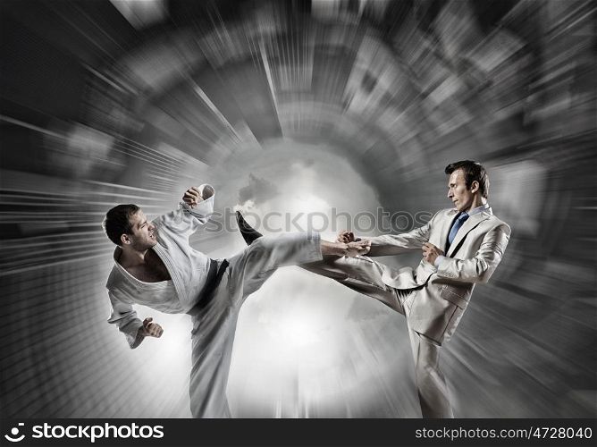 Karate man in white kimino. Young determined karate man fighting with businessman in suit