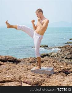 karateka practicing on the beach