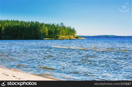 Karelian seascape at sunny day - granite cape with pine forest among the blue waves of Lake Onega.. Karelian Seascape At Sunny Day