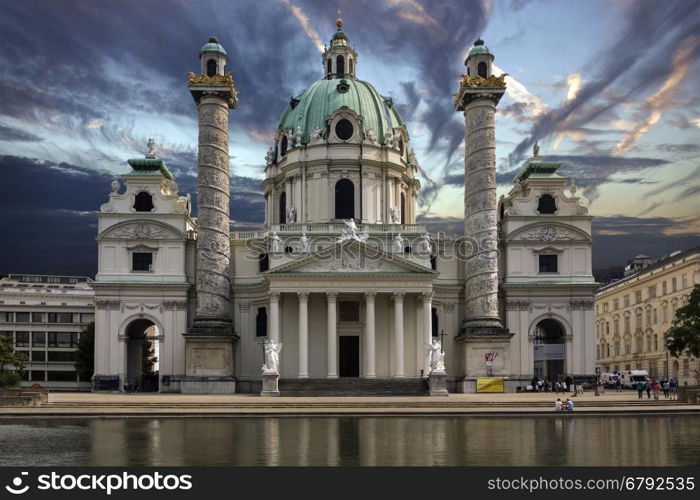 Karlskirche (St. Charles's Church) at dusk - Karlsplatz in Vienna, Austria. The most outstanding baroque church in Vienna, as well as one of the city's greatest buildings, Karlskirche is dedicated to Saint Charles Borromeo. In 1713, one year after the last great plague epidemic, Charles VI, Holy Roman Emperor, pledged to build a church for his patron saint, Charles Borromeo, who was revered as a healer for plague sufferers.
