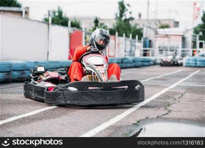 Karting racer in action, go kart competition on outdoor track. Carting championship