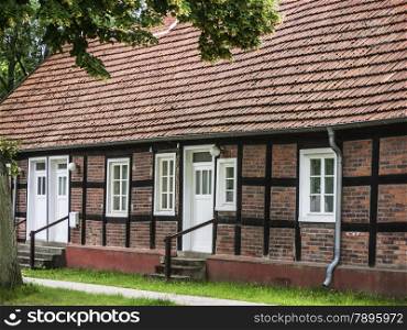 Karwe, Ostprignitz-Ruppin, Brandenburg, Germany. The small village Karwe located at Lake Ruppin belongs since 1993 to Neuruppin. Half-timbered house in the village center.