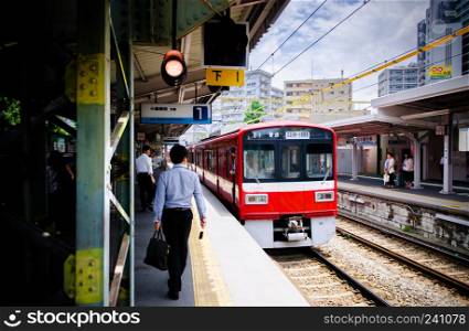 Kawasaki, JAPAN - June 27, 2014 : Passengers in local commutor train at Keikyu Kawasaki Daiji station, Kawasaki, Japan.