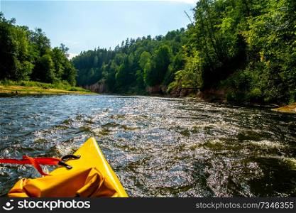 Kayak and canoe ride in river Gauja in Latvia. Boat ride by the river. Beautiful view of river from boat. The Gauja is the longest river in Latvia, which is located only in the territory of Latvia. Length - 452 km.