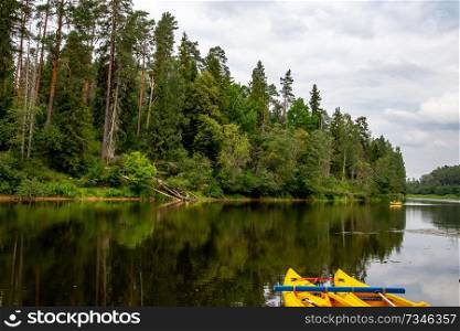 Kayak and canoe ride in river Gauja in Latvia. Boat ride by the river. Beautiful view of river from boat. The Gauja is the longest river in Latvia, which is located only in the territory of Latvia. Length - 452 km.

