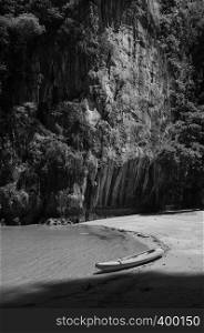 Kayak boat on beach at Rock island of Koh Talabeng near Koh Lanta, Krabi, Thailand. Black and white image