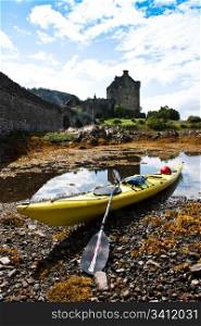Kayak in front of Eilean Donan Castle, Scotland