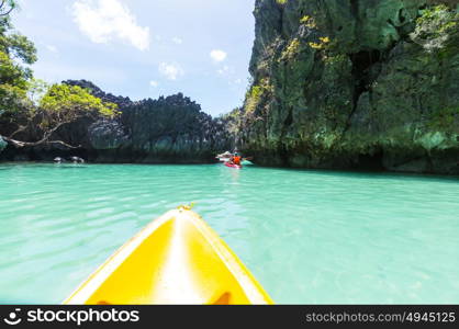 Kayak in the island lagoon between mountains. Kayaking journey in El Nido, Palawan, Philippines.